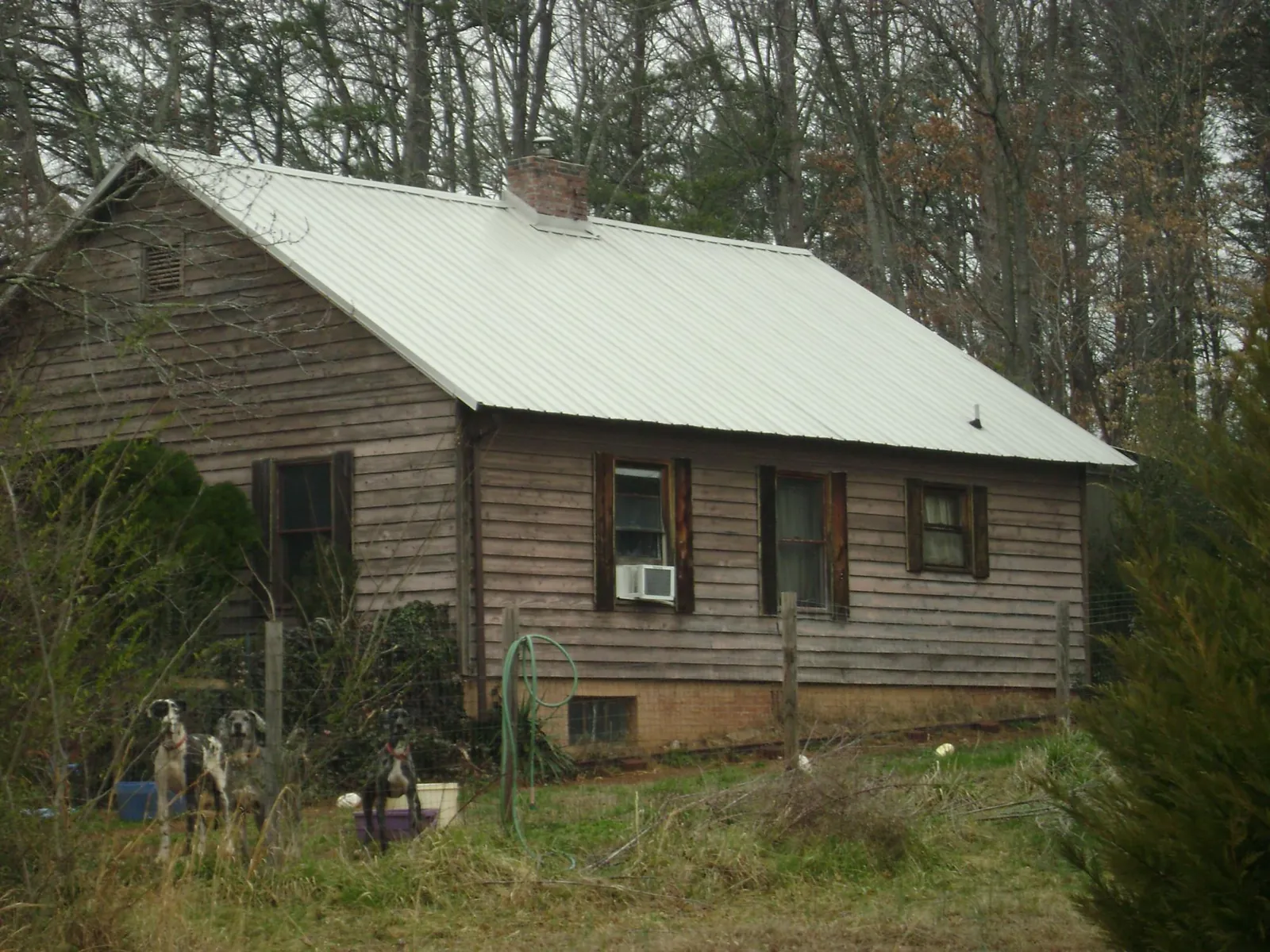 White metal roof on an old wood sided farmhouse, from a Metal Roof Installation job in Woodbridge